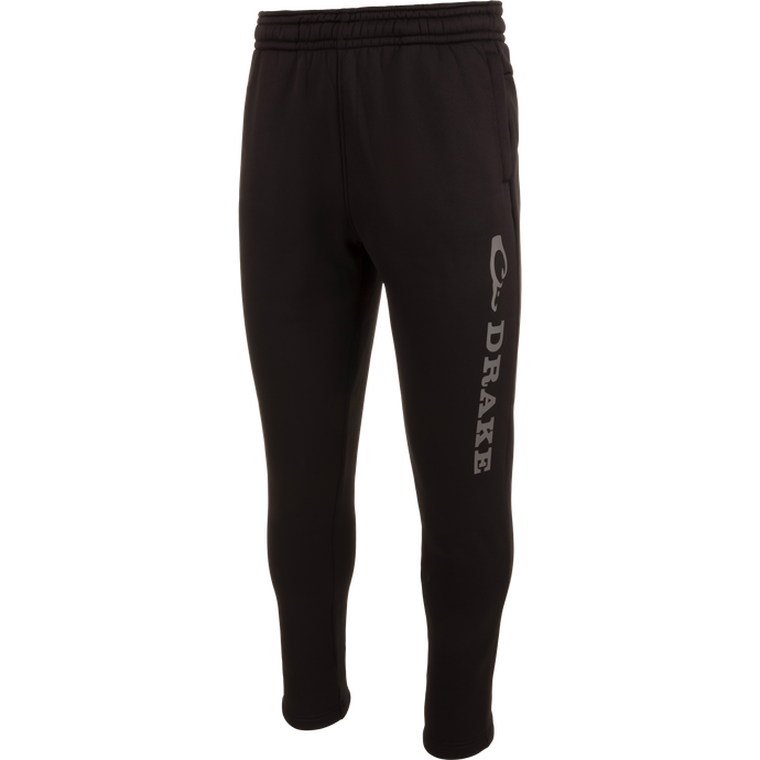 Drake Under-Wader Jogger with white text, featuring tapered legs, front slash pockets, and hook and loop closure back pockets, designed for comfort and durability under waders.