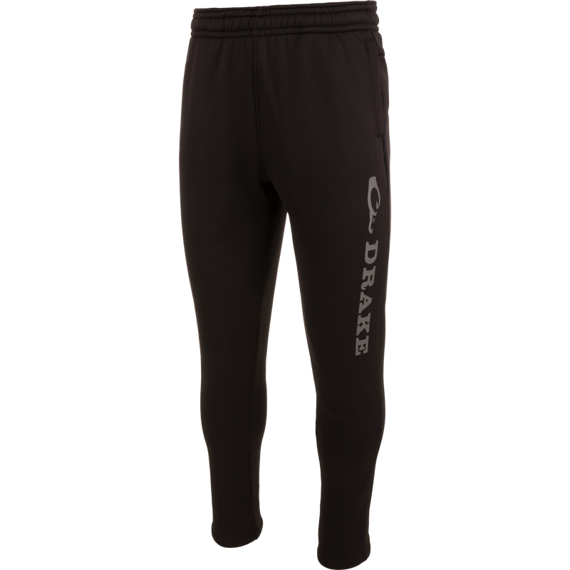 Drake Under-Wader Jogger with white text, featuring tapered legs, front slash pockets, and hook and loop closure back pockets, designed for comfort and durability under waders.