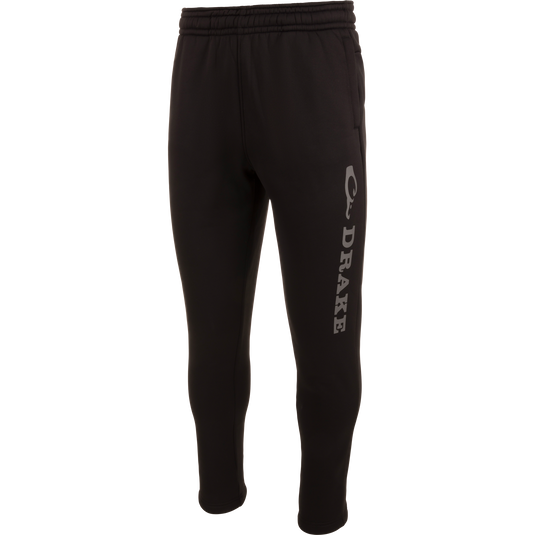 Drake Under-Wader Jogger with white text, featuring tapered legs, front slash pockets, and hook and loop closure back pockets, designed for comfort and durability under waders.