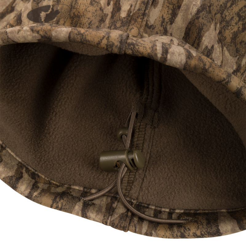 Close-up of the Endurance Jean Cut Wader Pant's fleece-lined fabric and zipper pull, showcasing its detailed craftsmanship and mid-weight design.