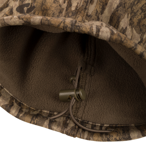 Close-up of the Endurance Jean Cut Wader Pant's fleece-lined fabric and zipper pull, showcasing its detailed craftsmanship and mid-weight design.