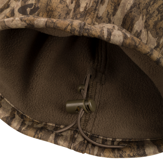 Close-up of the Endurance Jean Cut Wader Pant's fleece-lined fabric and zipper pull, showcasing its detailed craftsmanship and mid-weight design.