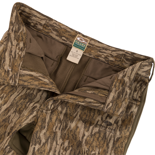 Close-up of the Endurance Jean Cut Wader Pant featuring camouflage pattern, front slash pockets, rear pockets, and adjustable waist.