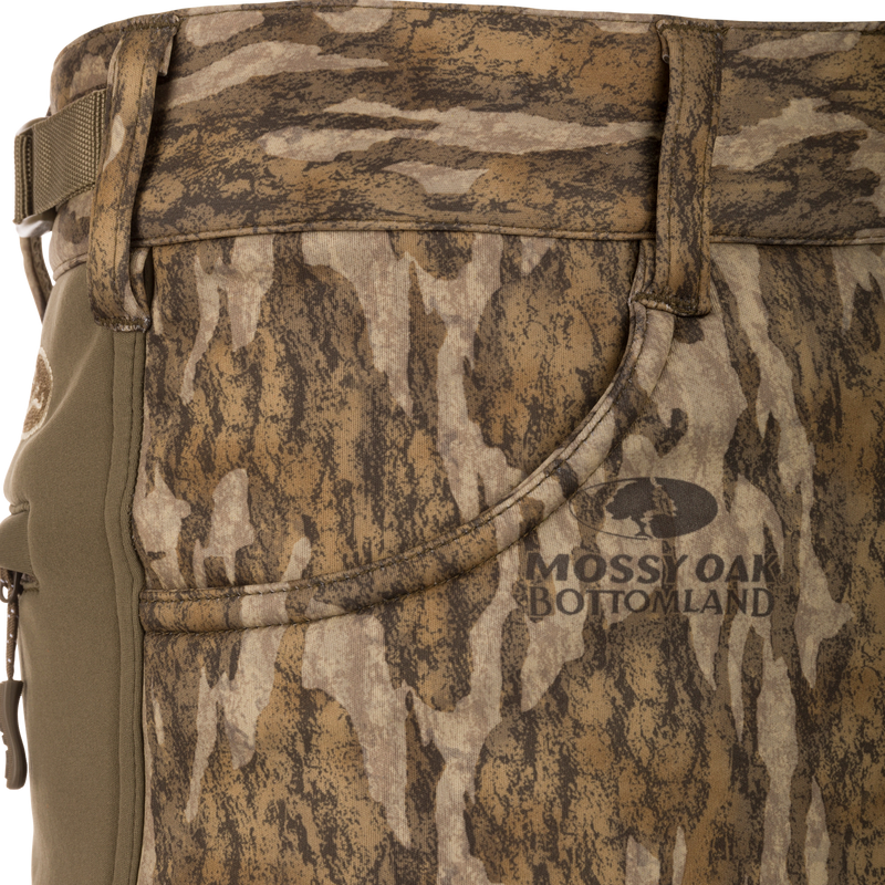 Close-up of Endurance Jean Cut Wader Pant in camouflage, showcasing the durable fabric, front slash pockets, and adjustable waist for optimal hunting comfort.