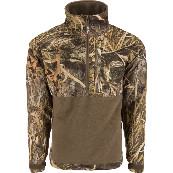 MST Half Zip Eqwader Jacket featuring a camouflage design, waterproof upper body, breathable fleece lower body, zippered pockets, and adjustable neoprene cuffs for optimal hunting comfort.