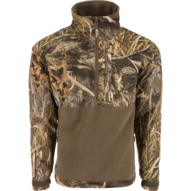 MST Half Zip Eqwader Jacket featuring a camouflage design, waterproof upper body, breathable fleece lower body, zippered pockets, and adjustable neoprene cuffs for optimal hunting comfort.