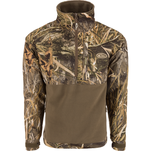 MST Half Zip Eqwader Jacket featuring a camouflage design, waterproof upper body, breathable fleece lower body, zippered pockets, and adjustable neoprene cuffs for optimal hunting comfort.