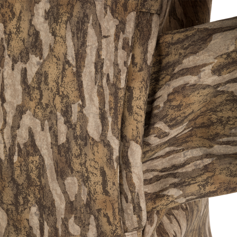 Close-up of the MST Ripstop Softshell Jacket's camouflage fabric, showcasing its durable Ripstop Stretch Tech Shell and bonded fleece lining.