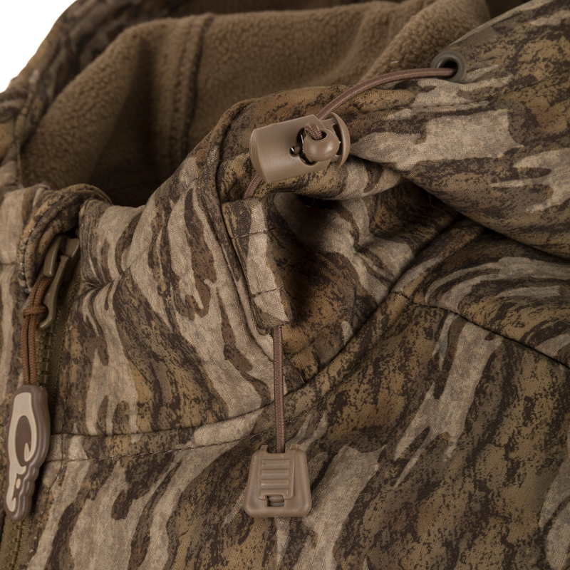 Close-up of the MST Ripstop Softshell Jacket showcasing its zippered chest pockets and durable polyester ripstop fabric with bonded fleece lining.