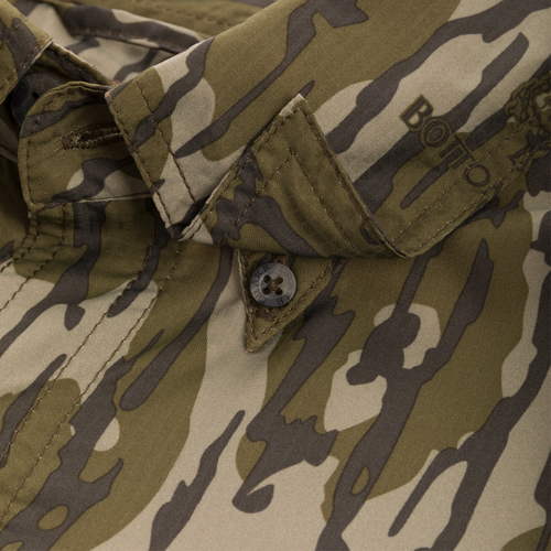 Close-up of the Long-Sleeved Flyweight Camo Hunting Shirt's button and fabric texture.