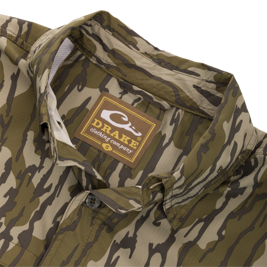 Close-up of the Long-Sleeved Flyweight Camo Hunting Shirt's fabric and label, showcasing its lightweight material and detailed craftsmanship.