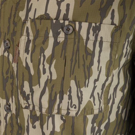 Close-up of the Long-Sleeved Flyweight Camo Hunting Shirt's pocket with button and hidden zipper details.