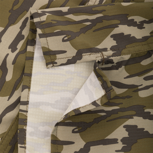 Close-up of the Drake Long-Sleeved Flyweight Camo Hunting Shirt, showcasing the classic Old School Camo pattern and technical features like hidden zippers and vented cape back.