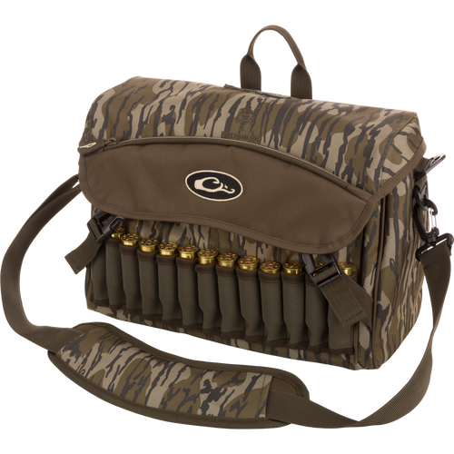 A rugged Shoulder Bag 2.0 by Drake Waterfowl, ideal for guides and outfitters. Features 650 cubic inches of storage, adjustable strap, durable hardware, and various pockets for hunting essentials. Dimensions: 13L x 9H x 5D.