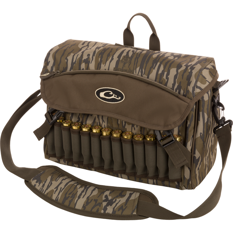 A rugged Shoulder Bag 2.0 by Drake Waterfowl, ideal for guides and outfitters. Features 650 cubic inches of storage, adjustable strap, durable hardware, and various pockets for hunting essentials. Dimensions: 13L x 9H x 5D.