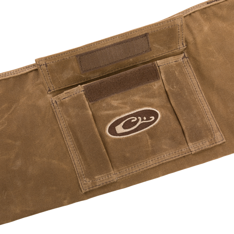 Wax Cotton Gun Sleeve featuring a brown logo, crafted from durable wax canvas, designed for safely transporting shotguns up to 50 inches.