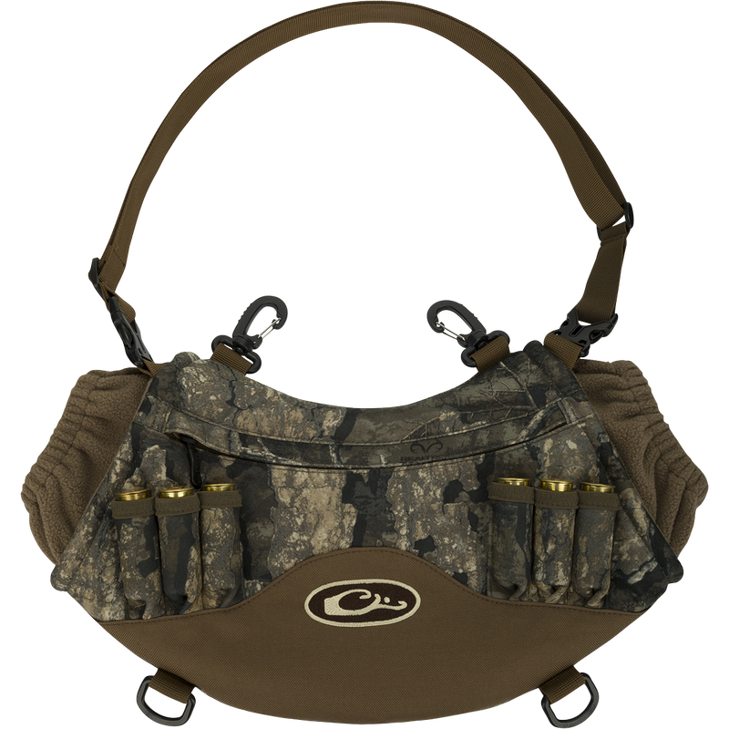 LST Handwarmer Muff with camouflage pattern, front storage pocket, clear waterproof phone pocket, carabiner clips, and quick-release waist belt for hunting convenience.