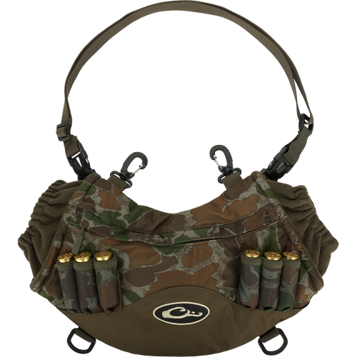 Camouflage Drake LST Handwarmer Muff with ammo loops, front storage pocket, clear waterproof phone pouch, waist belt, and carabiner clips for attaching to waders.