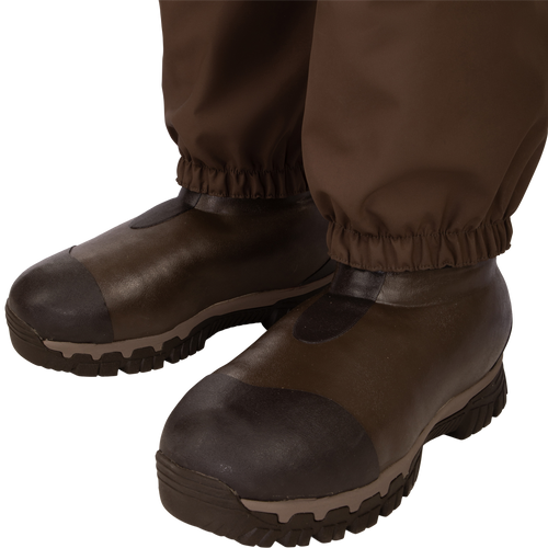 Uninsulated Guardian Elite HND Front Zip Wader - Original Treestand: A pair of brown boots with a close-up of a shoe. Perfect for outdoor hunting with waterproof, windproof, and breathable features.