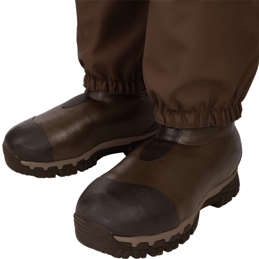 Uninsulated Guardian Elite HND Front Zip Wader - Original Treestand: A pair of brown boots with a close-up of a shoe. Perfect for outdoor hunting with waterproof, windproof, and breathable features.