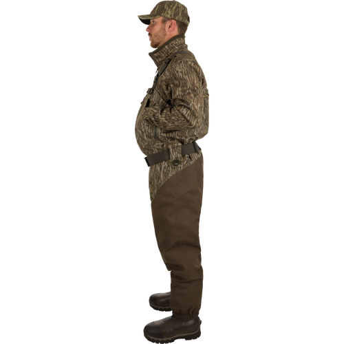 A man wearing the Guardian Elite Hybrid Insulated Front Zip Wader, featuring advanced waterproof and breathable fabrics, hybrid insulation, and reinforced seams for high-performance outdoor use.