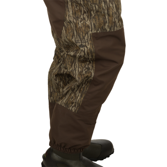 Insulated Guardian Elite Vanguard Breathable Wader - Old School, featuring camouflage pattern pants, jacket, and shoe. Waterproof, windproof, with LokDown insulation, Thinsulate boots, and handwarmer pockets. Ideal for hunting and fishing.