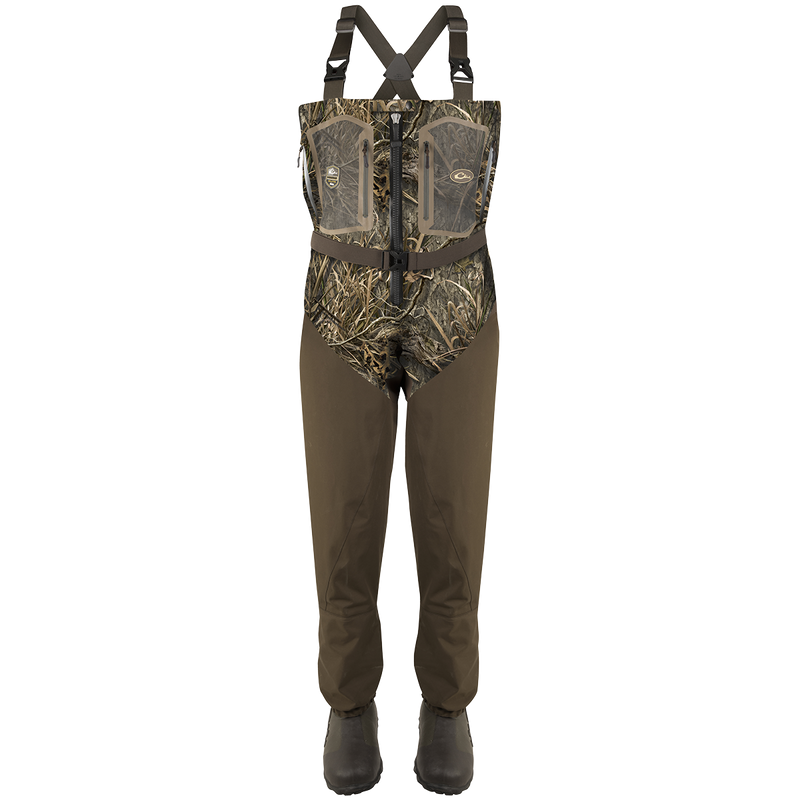 A pair of Guardian Elite Front Zip Insulated Waders with camouflage overalls, rugged boots, and adjustable shoulder straps.