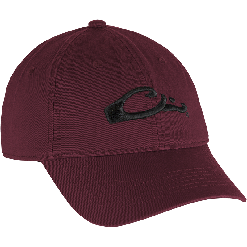 Cotton Twill Cap: A red hat with a black embroidered logo, featuring a low-profile design, brass buckle back strap, and contoured bill for comfortable, everyday wear.