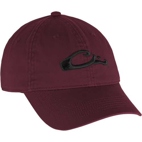 Cotton Twill Cap: A red hat with a black embroidered logo, featuring a low-profile design, brass buckle back strap, and contoured bill for comfortable, everyday wear.