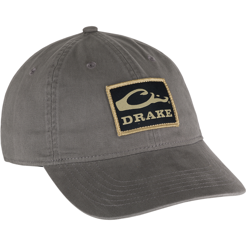 Cotton Twill Patch Cap featuring a grey design with a logo, low profile, contoured bill, and brass buckle back strap for comfort.