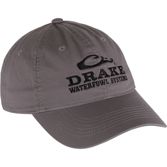 Cotton Twill Systems Cap: Grey, low-profile baseball cap with black text and brass buckle backstrap, designed for comfort and style in outdoor settings.