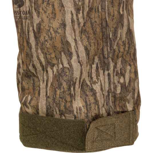 Youth Silencer Pant With Agion Active XL, featuring a camouflage design, ultra-quiet soft-shell fabric, and scent control technology, displayed on a black background.