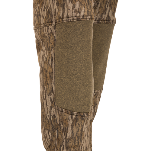 Youth Silencer Pant With Agion Active XL: Close-up of camouflage hunting pants featuring adjustable waist, ankle straps, and front and rear pockets, designed for quiet, comfortable deer stand use.