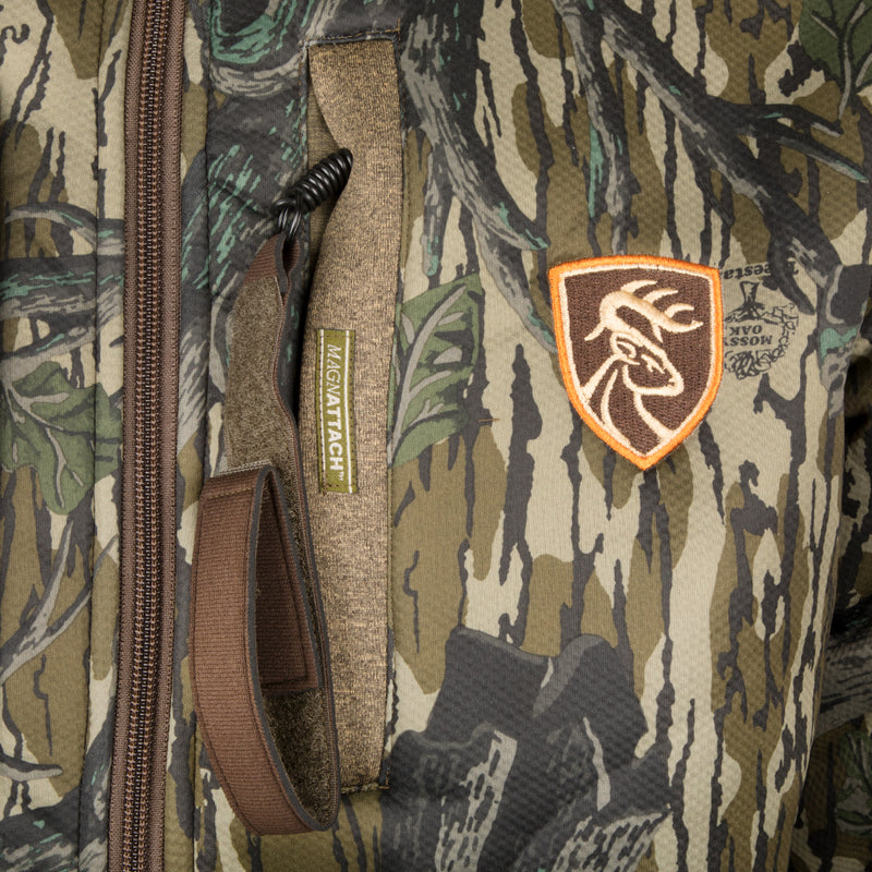 Silencer Full Zip Jacket Full Camo with Scent Control, featuring vertical chest pockets, camouflage fabric, and lanyards, designed for big game hunting.