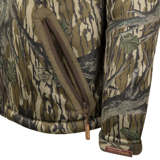 Close-up of the Silencer Full Zip Jacket Full Camo with Scent Control, showcasing durable fabric, vertical chest pockets, and Agion Active X2® scent control technology.