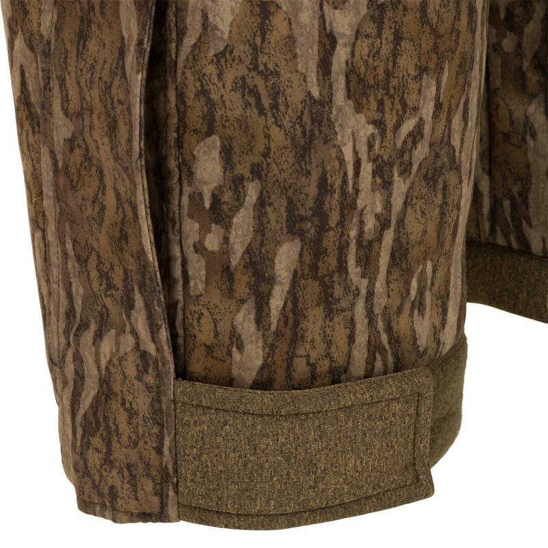 Close-up of the Youth Silencer Bib With Agion Active XL, showcasing camouflage fabric and durable construction, ideal for warmth and scent control during hunting.