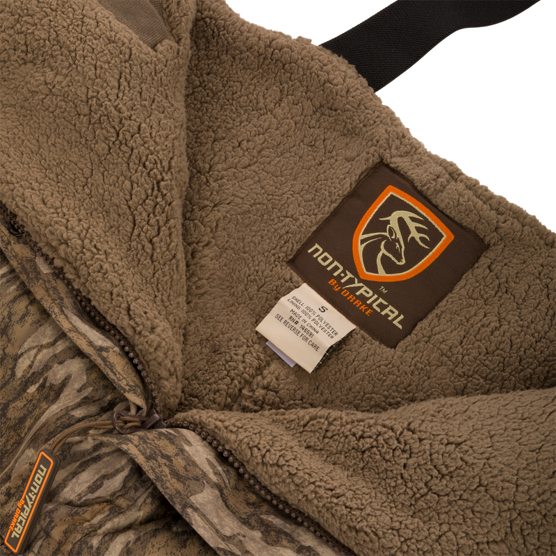 Close-up of Youth Silencer Bib with Agion Active XL, featuring durable outer fabric, Sherpa fleece interior, and visible labels highlighting its high-quality craftsmanship and scent control technology.