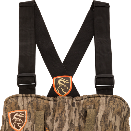 Silencer Bib camouflage vest with straps, featuring scent control technology, vertical pockets for hunting gear, and full-length side zippers for easy access.