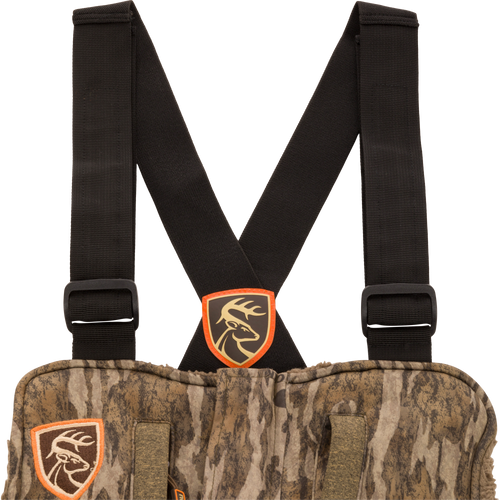 Women’s Silencer Bib With Agion Active XL featuring camouflage design, adjustable black straps, multiple pockets, and odor control technology for mid-season hunting.