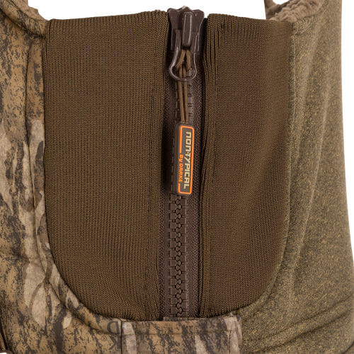 Close-up of the Youth Silencer Bib With Agion Active XL zipper, showcasing the durable fabric and vertical pocket for hunting gear.