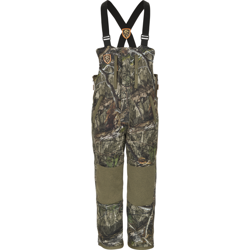 Camouflage Silencer Bib with Agion Active XL, featuring vertical pockets and lanyards, designed for durability, warmth, and scent control in hunting environments.