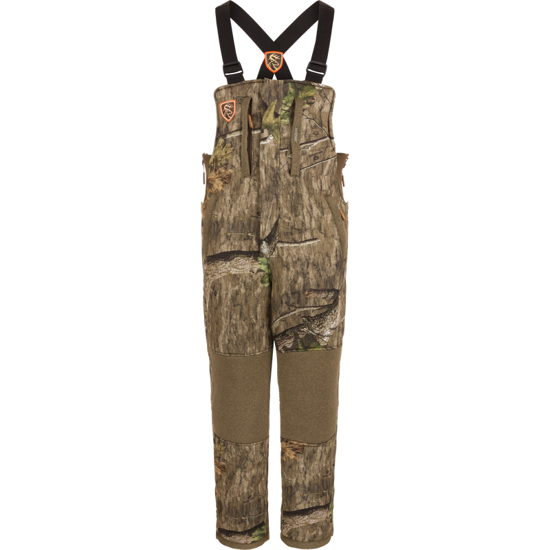 Silencer Bib with Agion Active XL®, featuring camouflage overalls with straps, durable fabric, vertical pockets with lanyards, and full-length side zippers for hunting.