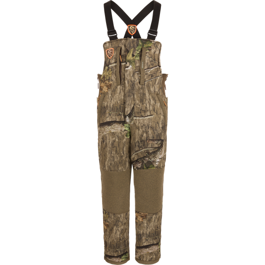 Silencer Bib with Agion Active XL®, featuring camouflage overalls with straps, durable fabric, vertical pockets with lanyards, and full-length side zippers for hunting.