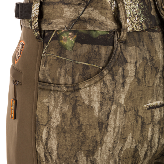 Close-up of the Non-Typical Endurance Pant, showcasing camouflage fabric, front slash pockets, and adjustable waist, designed for mid-season hunting comfort and protection.