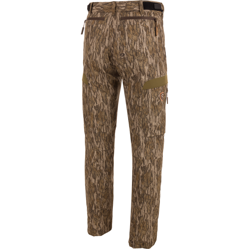 EST Camo Tech Stretch Pants with Scent Control featuring camouflage pattern, adjustable waistband, multiple zippered pockets, and elastic ankle cinch cord for versatile hunting comfort.