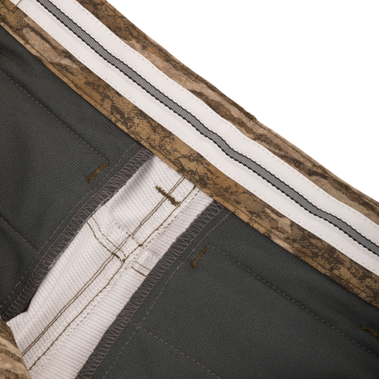 Close-up of EST Stretch Tech Pants with Scent Control, showcasing lightweight polyester fabric and multiple zippered pockets for practical hunting use.