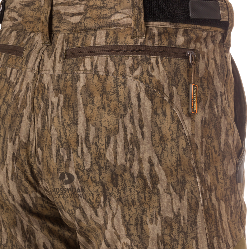 Close-up of EST Camo Tech Stretch Pants featuring zippered fly, side cargo pockets, and elastic ankle cinch cord for versatile hunting comfort and scent control.