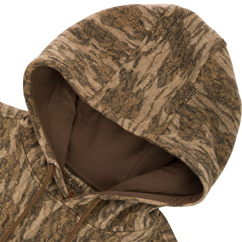 Non-Typical Three-End Camo Hoodie with kangaroo pocket, lined hood, adjustable drawstrings, and zipper details, shown in close-up.