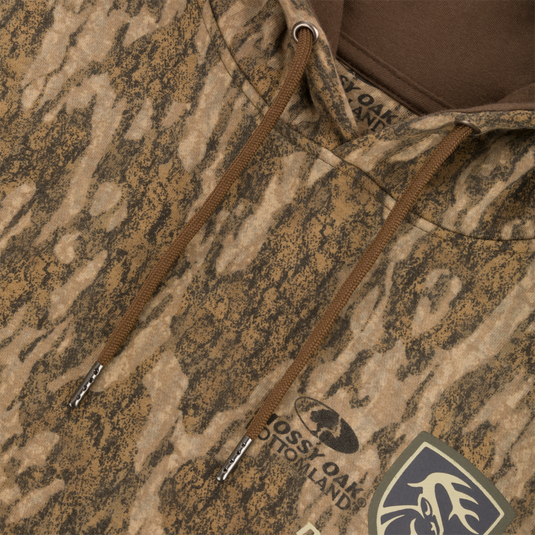 Close-up of the Non-Typical Three-End Camo Hoodie featuring a kangaroo pocket, adjustable drawstring hood, and camouflage pattern.