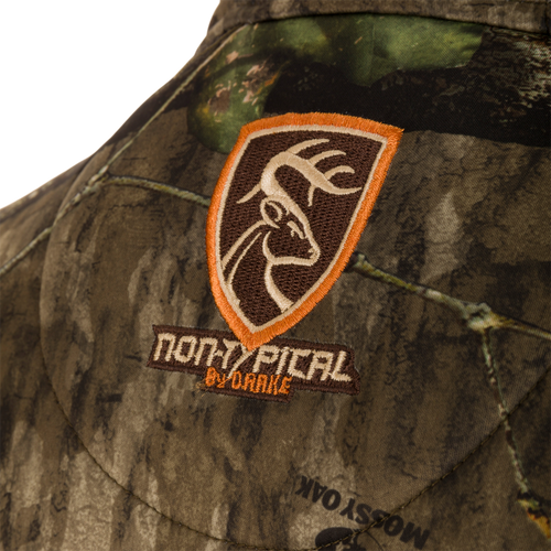 Close-up of the Non-Typical Endurance Hooded Full Zip Jacket, showcasing camouflage fabric and embroidered logo, with zippered pockets and adjustable hood visible.